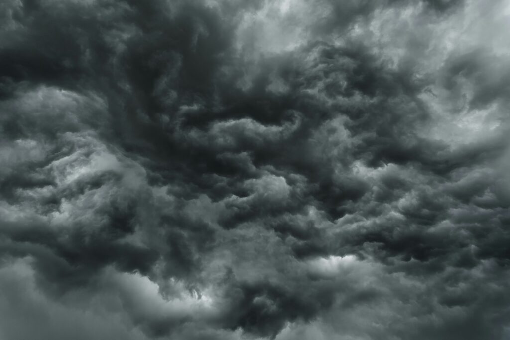 An image of dark grey clouds completely covering the sky. 